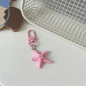 Cute pink starfish keychain bag pendant, girlish style metal clasp accessory for daily use.