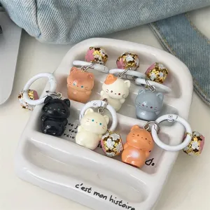 Cute standing cat keychain with bell, sweet cartoon animal bag charm accessory detail view.