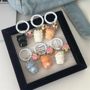 Cute standing cat keychain with floral bell, sweet cartoon bag pendant and lovely gift accessory.