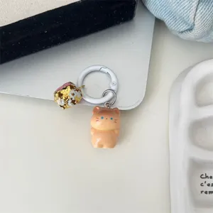 Cute standing cat keychain detail shot, featuring a resin figurine charm and a lovely bell.