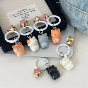 Cute standing cat keychain with kawaii bell pendant, soft cartoon animal accessory for bags.