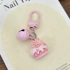 Süßer rosa Kirschblütenkuchen Schlüsselanhänger mit Glocke, ideale modische Taschen Deko.