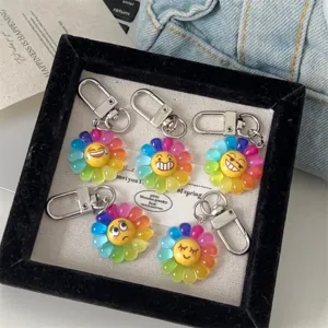 Colorful rainbow flower emoji keychain set with metal clasps, cute cartoon backpack pendant.
