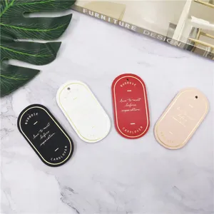 Close-up detail of minimalist oval leather bookmarks in four elegant colors with gold hot-stamped typography.
