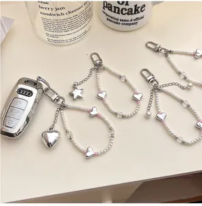 Detailed view of Korean ins style sweet pearl silver heart pendant keychain and phone strap.