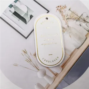 Oval leather bookmark with gold foil stamping, elegant page marker for book lovers.