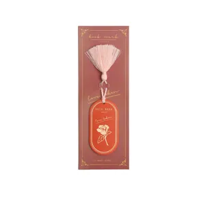 Oval leather bookmark with tassel and gold stamping, elegant page marker for reading books.