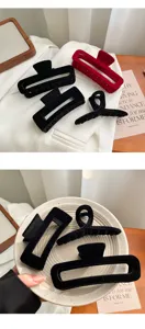 Detail view of stylish vintage velvet hair claws set in black and red, minimalist aesthetic accessory.
