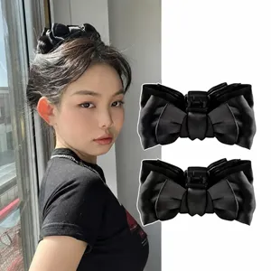 Detailed view of black velvet bow hair claw clip, elegant design for secure and stylish daily wear.