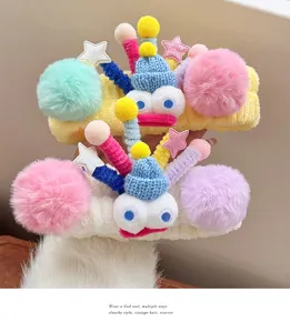 Cute plush big eye headband detail shot, colorful pom pom fluffy fuzzy hair hoop style.