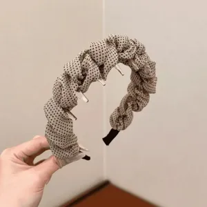 Korean polka dot fabric wrapped tooth headband for women, stylish hair hoop accessory detail shot.
