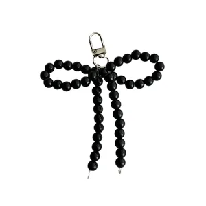 Ciondolo portachiavi a fiocco con perle nere elegante per borsa custodia telefono.