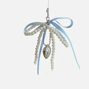 Pearl bow phone charm and bag pendant, cute aesthetic key chain accessory for lovely gifts.
