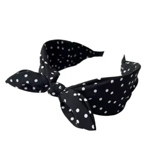 Retro black white polka dot bow headband for women, wide brim elegant hair hoop fashion accessory.