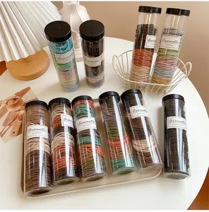 Cylindrical bottled colorful hair ties set, durable elastic hair bands for daily styling and ponytails.