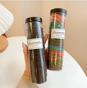 Bottled hair ties set, durable elastic rubber bands for ponytail styling and daily hair accessories.
