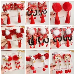 Chinese style red hair clips with bows tassels plush balls and cute rabbit designs for festival.