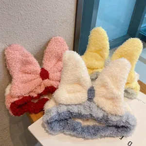 Fluffy plush bow headband for women, cute high skull top hair accessory, soft fuzzy winter style.