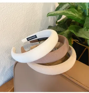 Detailed close-up shot of thick padded sponge headbands in neutral brown and white colors.