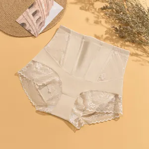 Close-up of high-waisted shaping panty, featuring delicate lace trim and abdominal support panel.