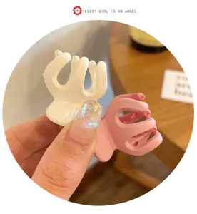 Matte finish mini hair claw clips set in white and pink, cute shark clips for hairstyles.