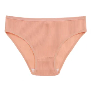 Comfortable women's seamless striped low-waist panties in peach pink solid knit fabric.