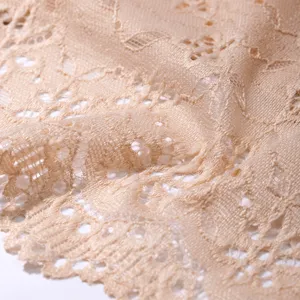 Soft beige floral lace fabric close-up, breathable cutout texture detail for women lingerie.
