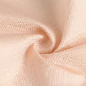 Close-up detail of seamless ice silk fabric texture in nude color, soft and smooth.