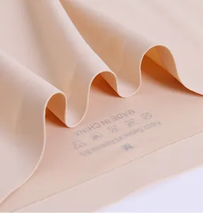 Seamless ice silk underwear fabric detail close-up showing soft texture and size label.