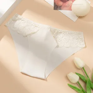 Detail shot of women's low waist seamless lace panties, breathable floral lace trim, white fabric close-up