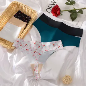 Close-up view of seamless ice silk thongs with cherry prints, displayed in a woven basket.