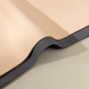 Close-up view of seamless underwear fabric and elastic waistband texture in neutral tones.
