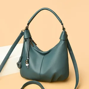 Dark green soft leather hobo crossbody bag with chic tassel charm for daily commute and casual chic.
