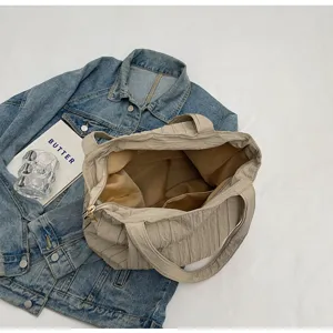 Detailansicht der beigen plissierten Canvas-Stofftasche, Innentasche und Textur, lässig.