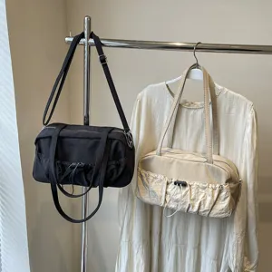 Detailansicht der modischen Damen Schultertasche mit Kordelzug und praktischen Fronttaschen.