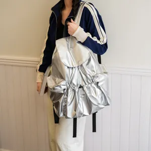 Silberner metallischer Freizeitrucksack mit Kordelzug und Vordertaschen für den Alltag.