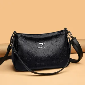 Schwarze Damen Umhängetasche aus echtem Leder mit elegantem Kleeblatt-Prägedesign.