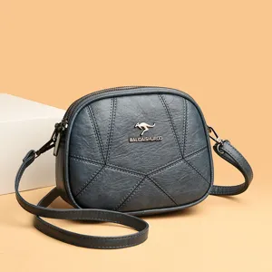Dunkelblaue Damen Umhängetasche mit geometrischen Nähten und kompakter runder Form.