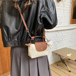 Mini Nylon Umhängetasche mit Henkel, Lederklappe und süßem Plüschanhänger für Damen.