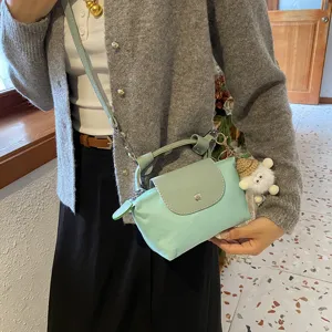 Kleine Nylon Umhängetasche für Damen, lässige Handtasche mit Griff und Klappe im modischen Stil.
