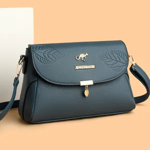 Elegante dunkelblaue Damen Umhängetasche aus Leder mit stilvollem geprägtem Blattmuster Design.
