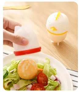 Silicone egg boiler detail view, cute cartoon chick shape, non-stick cooking mold for kitchen.