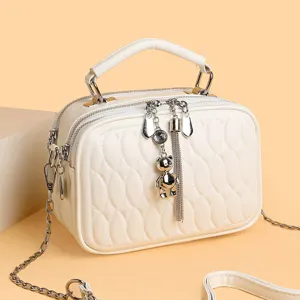 Weiße gesteppte Umhängetasche mit Bärenanhänger, stilvolle Handtasche mit Kette.