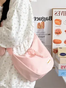 Rosa Segeltuch Umhaengetasche fuer Damen, stilvolle duempling Schultertasche mit geflochtenem Anhaenger.