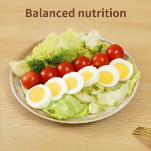 Fresh healthy salad bowl with sliced boiled eggs and vegetables for daily kitchen meal preparation.