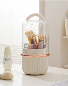 Rotatable makeup brush storage box with dustproof cover and portable handle for vanity.