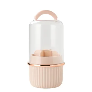 Rotary makeup brush storage box with dustproof clear cover and pink partitioned base.