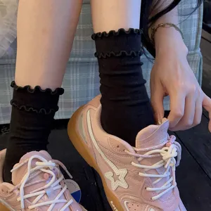Women black ruffle mid-tube socks sweet ballet style cotton socks detail view showcasing cute lace frills.