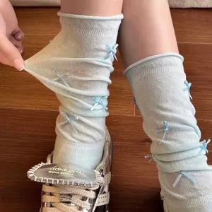 Light blue bow crew socks detail shot, cute ruffle design with elastic breathable fabric.