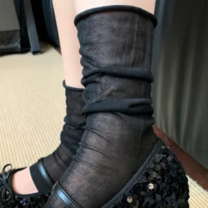 Close-up detail view of ultra-thin sheer black stackable socks worn with elegant shoes.